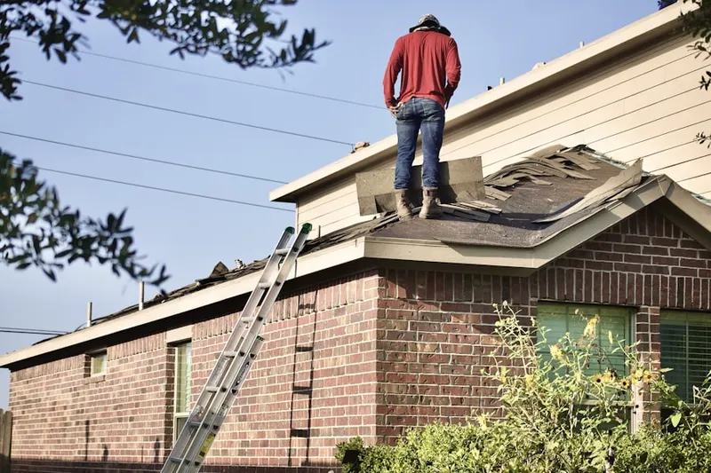 Professional roofer working on a residential roof in Nassau Shores